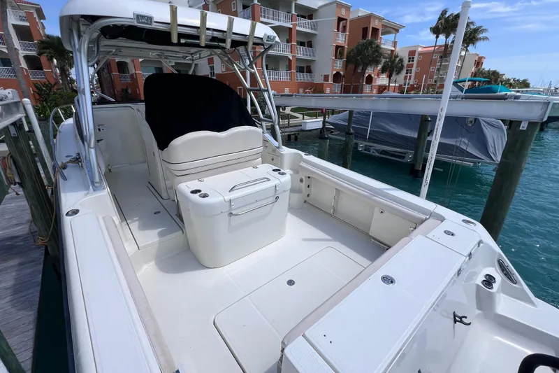 Slide: The Image of 2005 Hydra-Sports Vector 3300 VX docked, showcasing spacious deck and seating area. - 18