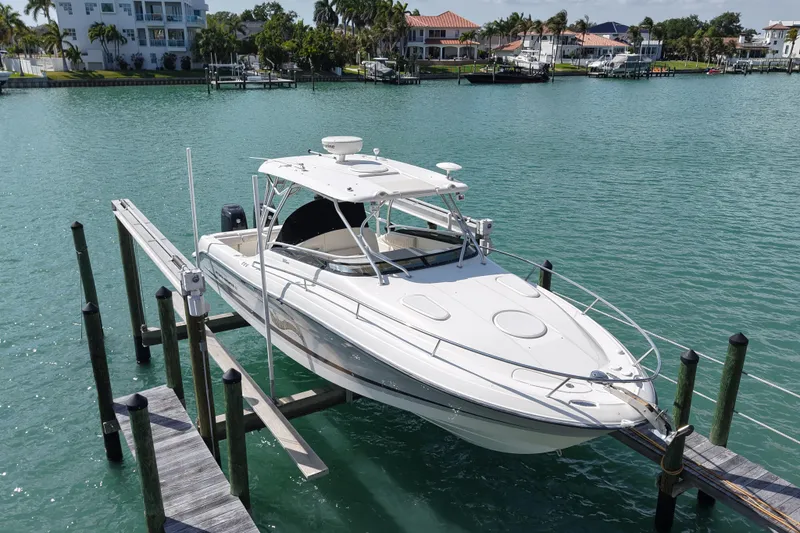 Slide: The Image of 2005 Hydra-Sports Vector 3300 VX boat docked in a scenic waterfront setting. - 2