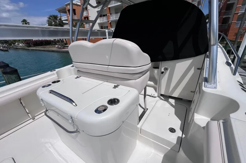 Slide: The Image of 2005 Hydra-Sports Vector 3300 VX boat interior with seating and storage, docked by waterfront. - 22