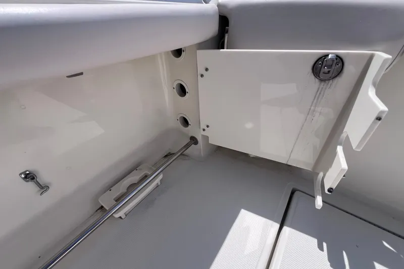 Slide: The Image of 2005 Hydra-Sports Vector 3300 VX boat interior with storage compartment and rod holder. - 24