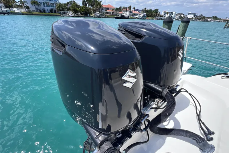 Slide: The Image of Twin Suzuki outboard motors on a 2005 Hydra-Sports Vector 3300 VX boat. - 25