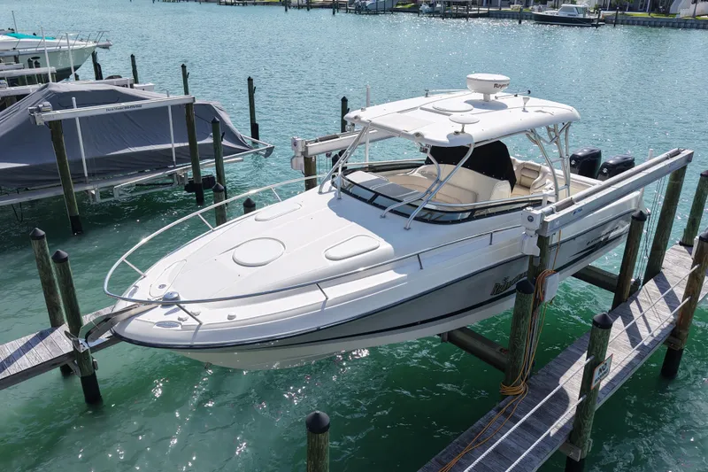 Slide: The Image of 2005 Hydra-Sports Vector 3300 VX boat docked on turquoise water. - 3