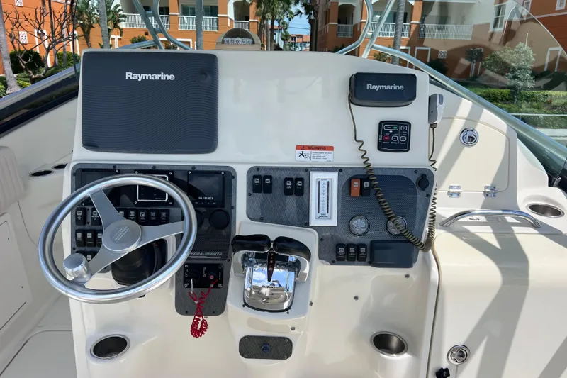 Slide: The Image of 2005 Hydra-Sports Vector 3300 VX helm with Raymarine electronics and steering wheel. - 32