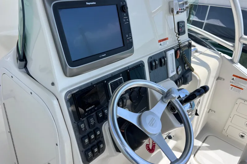Slide: The Image of 2005 Hydra-Sports Vector 3300 VX boat dashboard with steering wheel and navigation controls. - 33