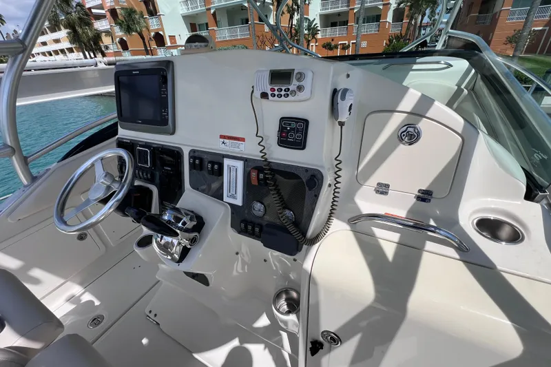 Slide: The Image of 2005 Hydra-Sports Vector 3300 VX boat cockpit with steering wheel and control panel. - 34