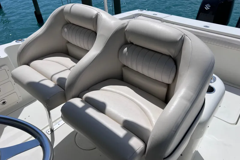 Slide: The Image of 2005 Hydra-Sports Vector 3300 VX boat seats, featuring plush white leather upholstery. - 37