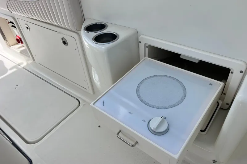 Slide: The Image of 2005 Hydra-Sports Vector 3300 VX boat interior with built-in stove and cup holders. - 42