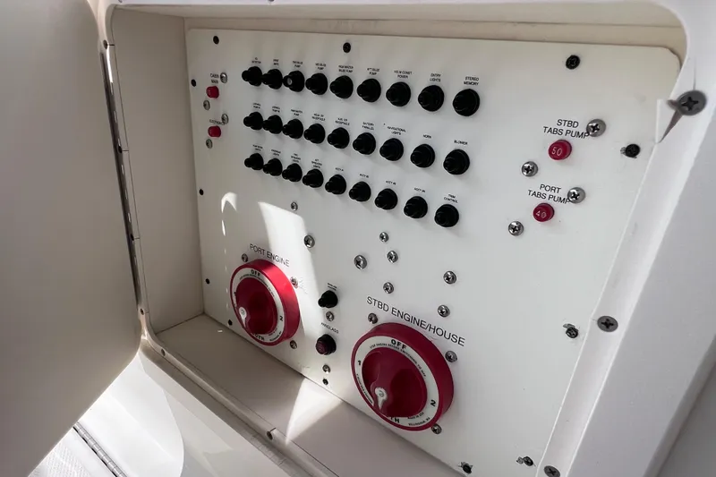 Slide: The Image of Control panel of a 2005 Hydra-Sports Vector 3300 VX boat, featuring switches and dials. - 49