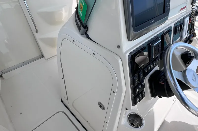 Slide: The Image of 2005 Hydra-Sports Vector 3300 VX helm with steering wheel and control panel. - 51