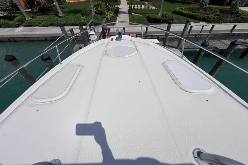 Slide: The Image of 2005 Hydra-Sports Vector 3300 VX boat deck, docked near lush greenery. - 62