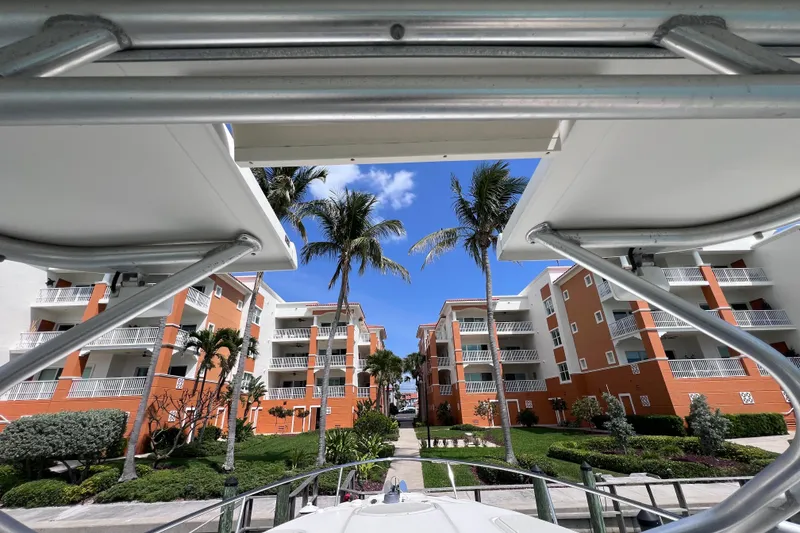 Slide: The Image of 2005 Hydra-Sports Vector 3300 VX docked near tropical apartments with palm trees. - 64