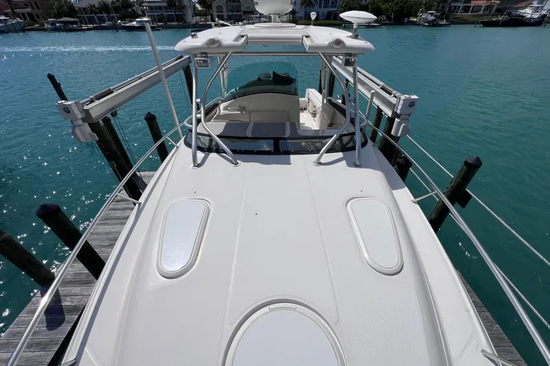 Slide: The Image of 2005 Hydra-Sports Vector 3300 VX boat docked on clear blue water. - 66