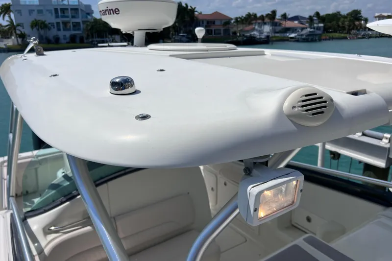 Slide: The Image of 2005 Hydra-Sports Vector 3300 VX boat roof with radar and light, docked near waterfront homes. - 70