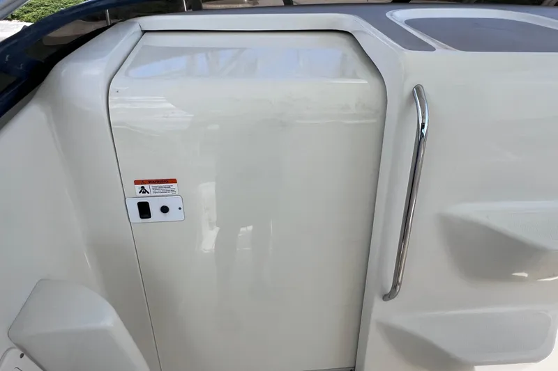 Slide: The Image of 2005 Hydra-Sports Vector 3300 VX cabin door with chrome handle and warning label. - 71