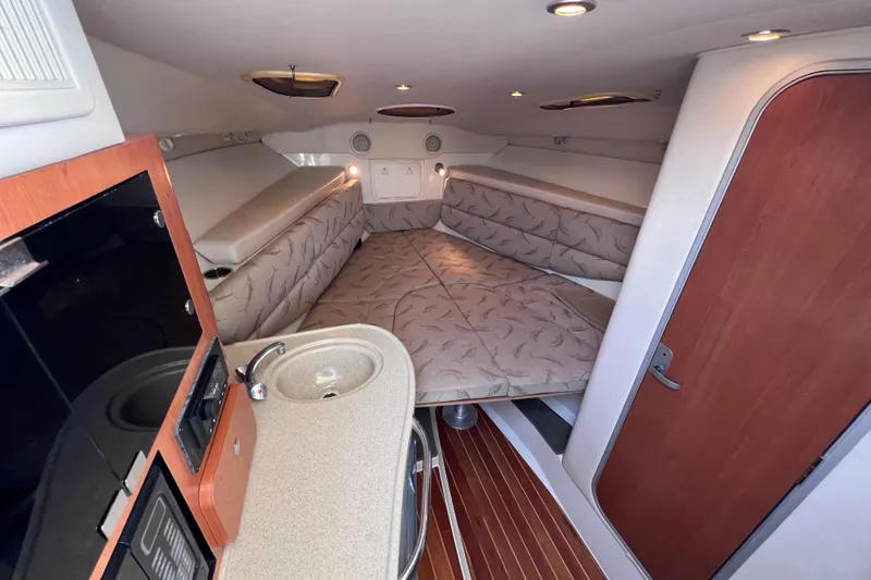 Slide: The Image of 2005 Hydra-Sports Vector 3300 VX cabin interior with bed, sink, and wood accents. - 75