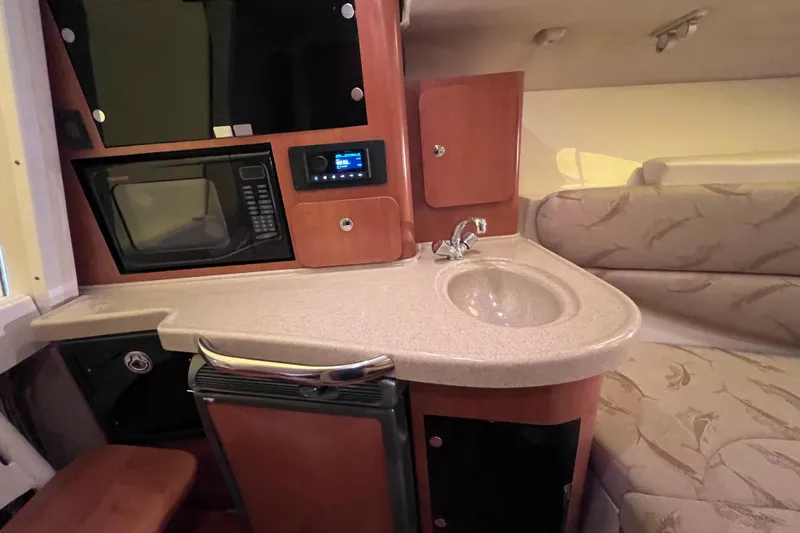 Slide: The Image of 2005 Hydra-Sports Vector 3300 VX cabin interior with kitchenette, sink, and seating area. - 76