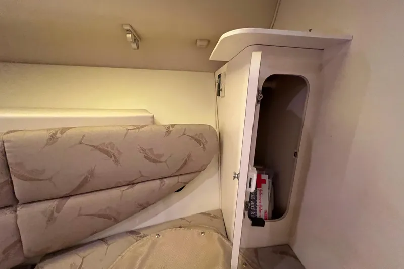 Slide: The Image of 2005 Hydra-Sports Vector 3300 VX cabin interior with cushioned seating and storage compartment. - 78