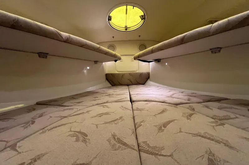 Slide: The Image of 2005 Hydra-Sports Vector 3300 VX cabin interior with patterned upholstery and overhead lighting. - 80