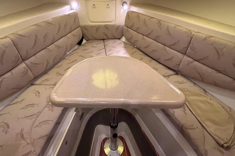 Slide: The Image of 2005 Hydra-Sports Vector 3300 VX cabin interior with cushioned seating and table. - 83