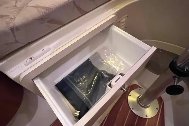 Slide: The Image of Open drawer on 2005 Hydra-Sports Vector 3300 VX boat, containing a sealed plastic bag. - 85