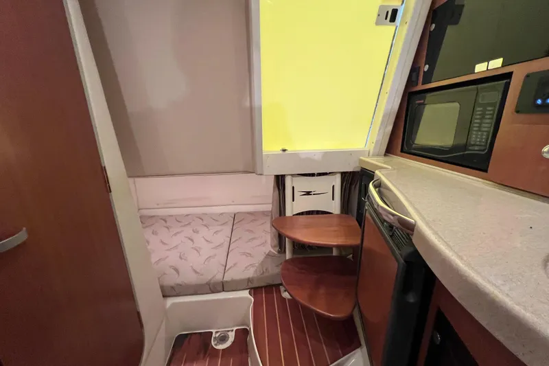 Slide: The Image of 2005 Hydra-Sports Vector 3300 VX cabin interior with kitchenette and seating area. - 86