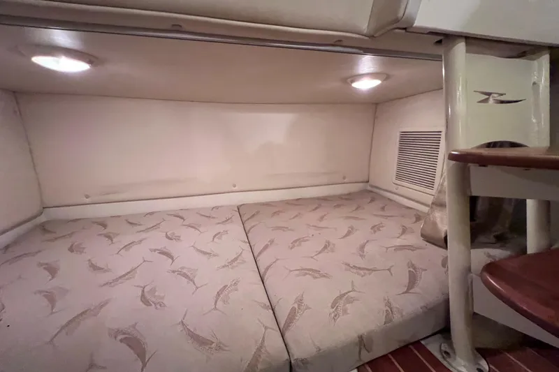 Slide: The Image of 2005 Hydra-Sports Vector 3300 VX cabin interior with patterned bedding and ambient lighting. - 87