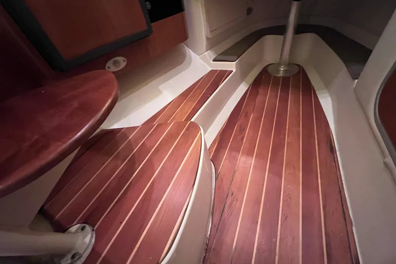 Slide: The Image of 2005 Hydra-Sports Vector 3300 VX cabin interior with wooden flooring and seating. - 90