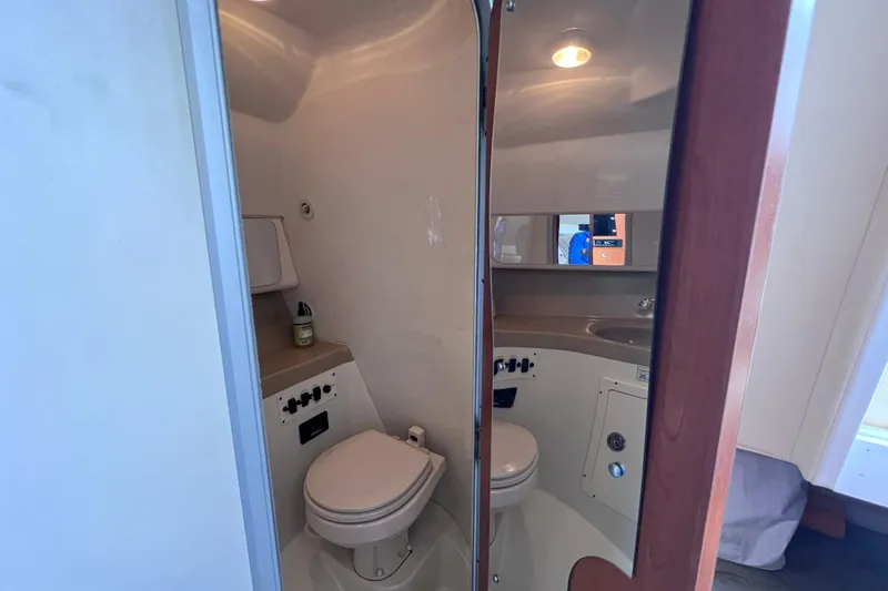 Slide: The Image of 2005 Hydra-Sports Vector 3300 VX boat bathroom interior with toilet and sink. - 94