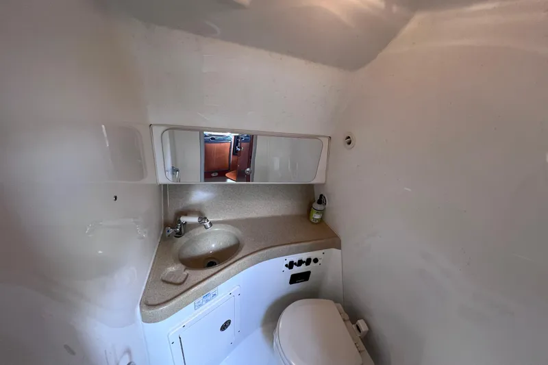 Slide: The Image of 2005 Hydra-Sports Vector 3300 VX boat bathroom with sink, mirror, and toilet. - 95