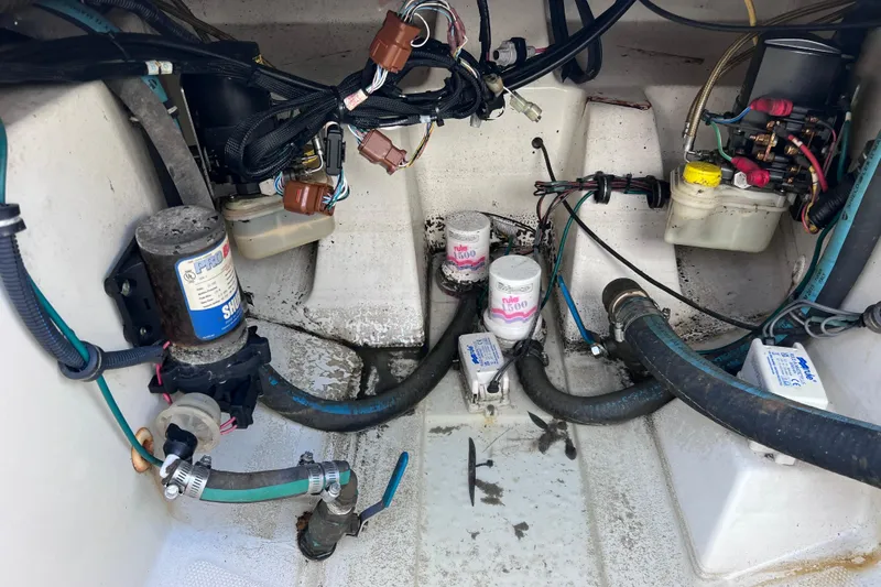 Slide: The Image of 2005 Hydra-Sports Vector 3300 VX engine compartment with wiring and pumps visible. - 98