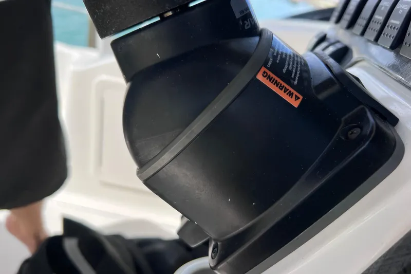 Slide: The Image of Close-up of a 2005 Hydra-Sports Vector 3300 VX boat control panel with warning label. - 99