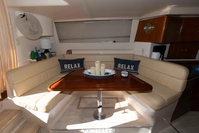 Slide: The Image of Interior of 2003 Carver 350 Mariner with cozy seating and "Relax" pillows. - 16