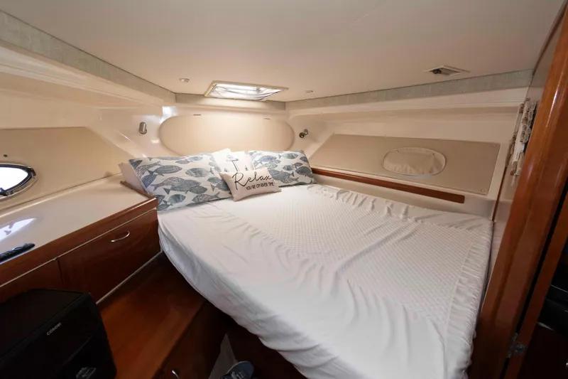 Slide: The Image of Cozy bedroom in 2003 Carver 350 Mariner yacht with plush bedding and wooden accents. - 19