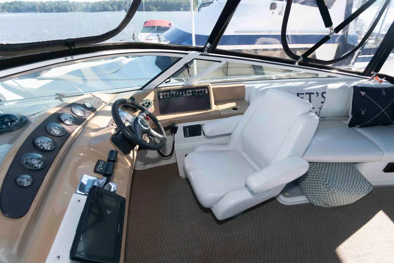 Slide: The Image of 2003 Carver 350 Mariner helm with white captain's chair and modern dashboard controls. - 5