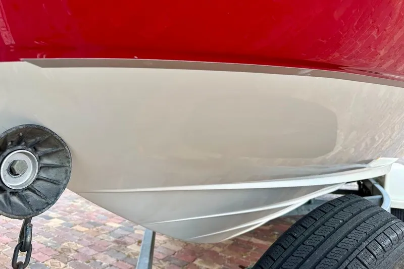 Slide: The Image of Close-up of 2004 Sea Ray 200 Sundeck boat hull and trailer wheel. - 4