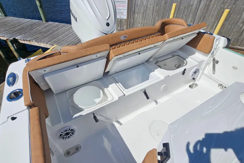 Slide: The Image of 2026 Sea Hunt Ultra 255 SE boat interior with storage compartments and seating. - 11