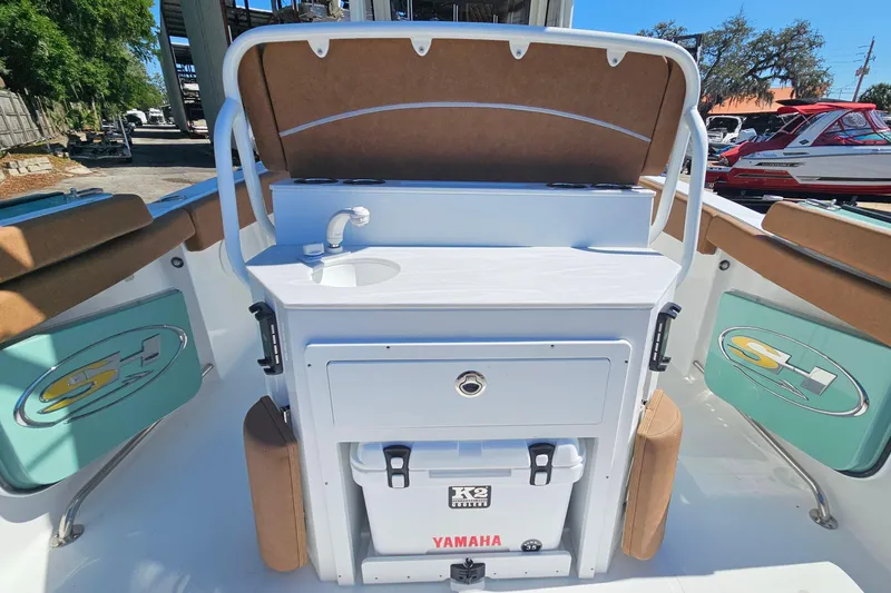 Slide: The Image of 2026 Sea Hunt Ultra 255 SE boat interior with sink and storage area. - 12