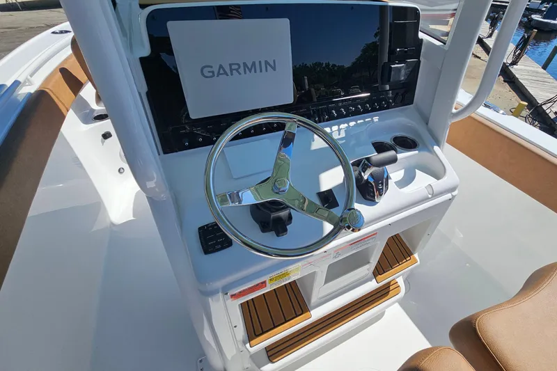 Slide: The Image of 2026 Sea Hunt Ultra 255 SE boat dashboard with Garmin navigation system and steering wheel. - 17