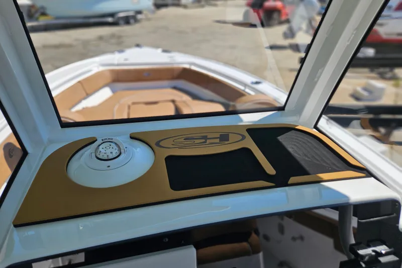 Slide: The Image of 2026 Sea Hunt Ultra 255 SE boat interior with compass and dashboard details. - 20