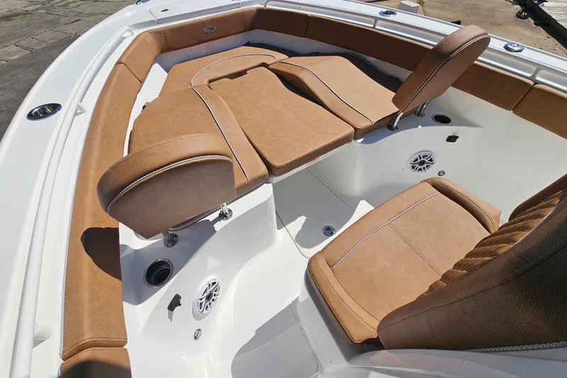 Slide: The Image of Luxurious seating on 2026 Sea Hunt Ultra 255 SE boat, featuring tan upholstery and sleek design. - 23