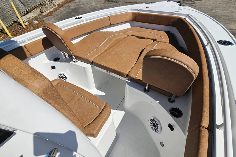 Slide: The Image of 2026 Sea Hunt Ultra 255 SE boat interior with tan seating and white deck. - 24