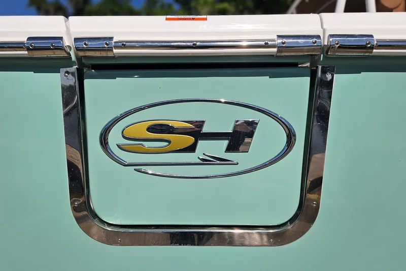 Slide: The Image of 2026 Sea Hunt Ultra 255 SE logo on a light green boat exterior. - 5