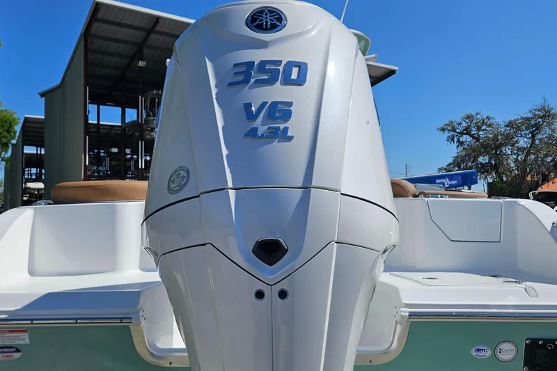 Slide: The Image of 2026 Sea Hunt Ultra 255 SE boat with powerful 350 V6 engine, docked outdoors. - 7