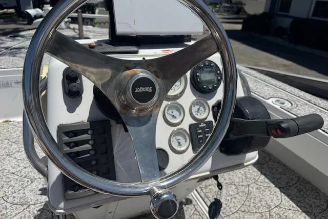 Slide: The Image of Steering console of a 2004 Ranger 191 Cayman boat with gauges and controls. - 10