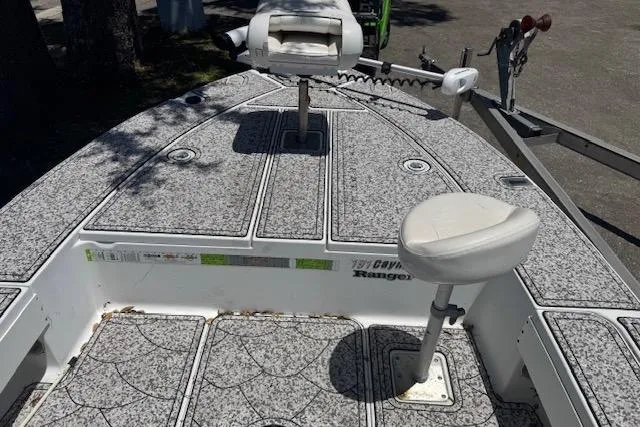 Slide: The Image of 2004 Ranger 191 Cayman boat deck with seating and fishing equipment. - 12