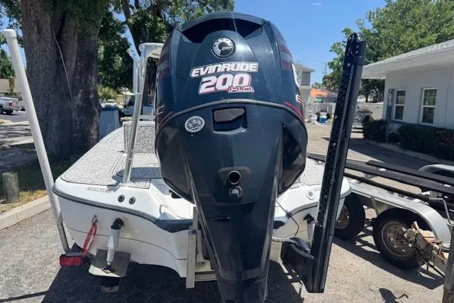 Slide: The Image of 2004 Ranger 191 Cayman boat with Evinrude 200 HP engine, parked on a trailer. - 3
