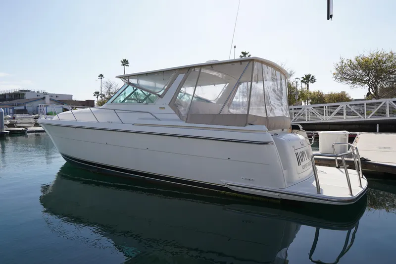 Slide: The Image of 1994 Tiara Yachts 4000 Express docked at marina, side view. - 12