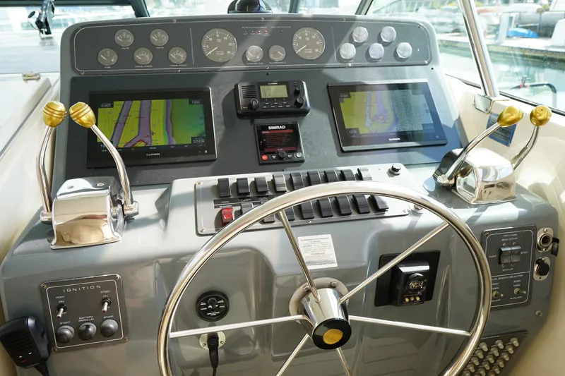 Slide: The Image of 1994 Tiara Yachts 4000 Express helm with dual screens and navigation controls. - 17