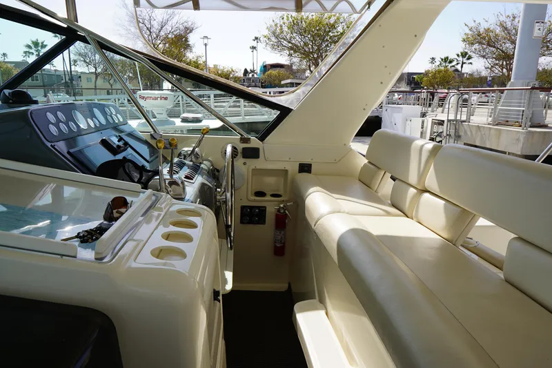 Slide: The Image of 1994 Tiara Yachts 4000 Express interior with helm, seating, and control panel. - 18