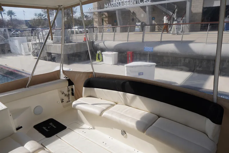 Slide: The Image of 1994 Tiara Yachts 4000 Express interior with marina view and seating area. - 19